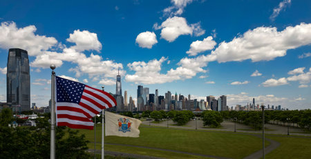New York City near American flag, United States, USA. NYC skyline. Panorama of New York. New York skyscrapers. Beautiful view in Manhattan, Empire State Building in NYC. The New York Times Building.の写真素材
