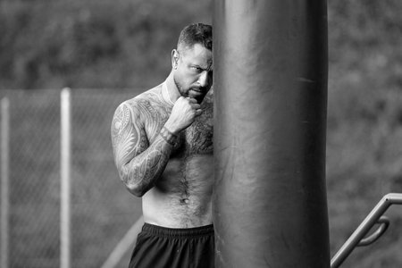 Punch. Muscular sport man. Fists fight. Mans fight, punches. Kicks up. In the outdoor boxing arena....