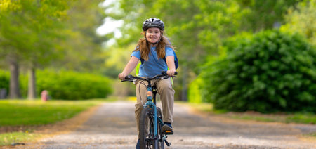 Child on bicycle. Teen boy biking down summer road. Kid riding bicycle with smile. Child cycling. Kid ride on bike. Happy boy on bicycle. Child biking outdoors. Children biking. Cute child on bicycle.の写真素材