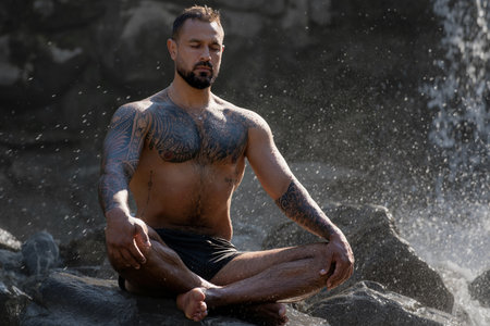 Meditation man with fit body. Muscular male meditation in lotus pose. Guy practicing yoga. Meditation in nature. Mental balance. Abdominal flexible body. Belly vacuum exercise. Zen meditation.の写真素材