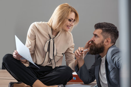 Boss and secretary having a conversation in the office.の写真素材