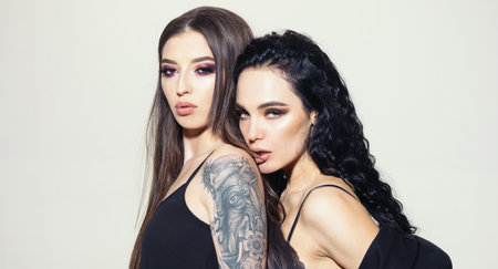 Lesbians girls kissing with love. Lesbian kiss. Lesbian couple kissing. Lesbian couple embrace with passion and desire. Closeup of two Lesbian kissing. Sexy models in love. Sensual kiss.の写真素材