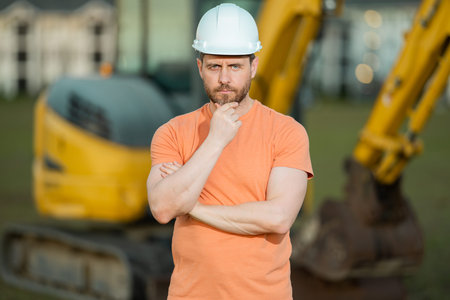 Builder with excavator for construction at the construction site. Machinery tractor with builder at...