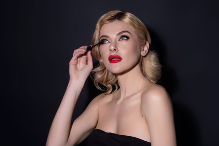 Perfect eyelashes. Natural beauty lashes. Eyelashes coloring and lamination. Woman combing lashes. Makeup and cosmetology concept. Eyelashes shape modeling.の写真素材