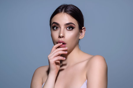 Emotional student girl shocked with news covering mouth with hands. Young emotional woman. The human emotions, facial expression concept. Amazed girl with shocked facial expression.の写真素材