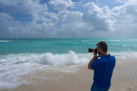 Mature man photographer. Man photographer with a camera on vacation. Traveler photographer by the...