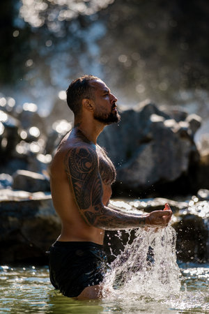 Healthy life strong man outdoors. Fit muscular male summer portrait. Healthy lifestyle man in nature. Athletic guy water splash. Healthy man. Fitness lifestyle. Healthy body. Man in nature.の写真素材