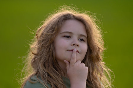 Kid looking away. Child thinking with a doubtful look. Portrait of a child imagining deeply. Dreamy...