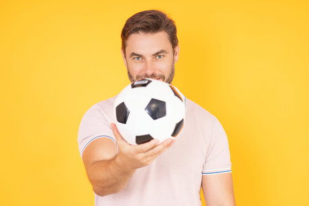 Man hold football ball. Sport victory. Excited man holding soccer ball in studio. Football fan...