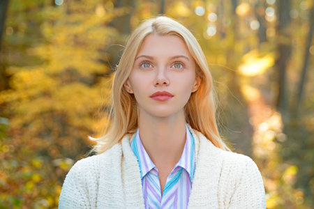 Portrait of woman walking outdoors in autumn day. Woman on autumn background. Woman with autumn leaves. Girl in autumn fall leaves park. Girl on autumnal fall background. Foliage, falling leaves.の写真素材