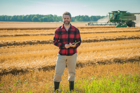 The harvest. Farmer working in field. Farming in the countryside. Farm landscape with harvest...
