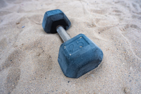 Sports equipment. Dumbbells background. Dumbbell on the beach for summer sport. Dumbbells in sand. Workout with dumbbells in public gym. Healthy lifestyle background. Sport banner with dumbbells.の写真素材