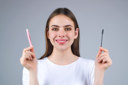 Woman comb eyebrows with eyebrow brush. Care for brows, eyebrows lamination. Brow beauty procedures. Beautiful woman with long eyelashes, eyebrows.の写真素材