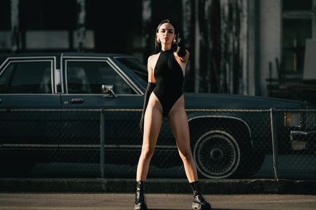 Sexy woman with finger gun. Female model with Bang-bang hand gun gesture sign. Shooting fingers. Beautiful woman holding a fingers in gun pistol pow gesture. Pretty girl with gun Hands.の写真素材