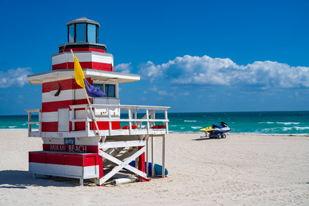 Miami Beach lifeguard at the summer beach. Tourism on South Miami Beach. Sky above lifeguard tower in Miami. Iconic lifeguard tower on sand in Miami. A symbol of Miami's coast.の写真素材