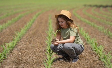 Eco farm. Child in eco-friendly corn field. Farming in green ecosystem. Eco farming concept. Organic...