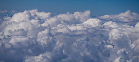 Dreamy cloudscape above. Sky with white clouds. Sky background design. Many clouds. Puffy cumulus...