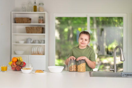 Kids eating healthy breakfast in modern kitchen. Happy kids eating fresh fruits in home kitchen. Cute kids eating vegetarian meal in cozy kitchen. Kids eating tasty homemade food in white kitchen.の写真素材