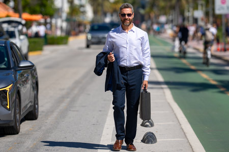 Business man walking confidently in the city. Business man walking down the street. Handsome...
