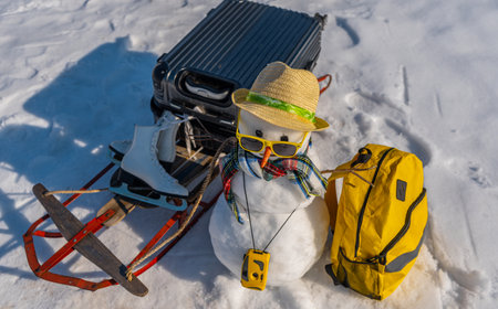 Snowman traveler with suitcase. Winter adventure with snow man. Funny snowman tourist. Christmas...