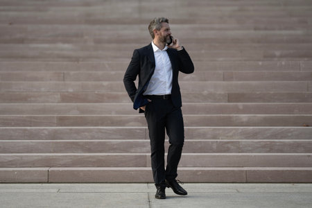 Business man walking up stairs. Career growth and success. Business step. Future goal and victory. Manager on stairs. Man climbing on stairs. Man in a suit moving up stairs. Goal concept.の写真素材
