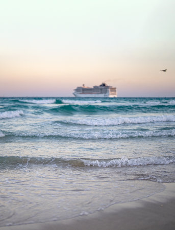 Cruise ship on the ocean. Luxury liner at ocean waves water. Miami Beach with cruise ship. Turquoise water and cruise liner. Tourist cruise ship near the coast. Ocean waves and vessel boat.の写真素材
