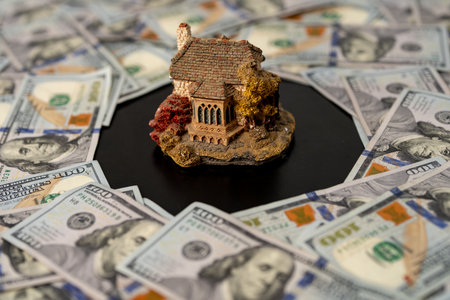 Real estate with money. Home buying concept. Home mortgage and insurance. Dollars purchase for...
