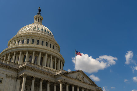 Washington DC Capitol with American flag closeup. American flag over Congress. Famous landmark in...