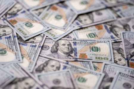 Money background with 100-dollar bills. Texture of US money currency. 100 USD banknotes in focus....