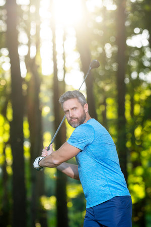 Playing golf. Man swing golf ball during outdoor training. A golfer play golf in golf club on a...
