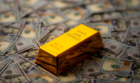 Gold bars and money. Golden bars stacked with US dollars in background. Gold bars for secure capital...