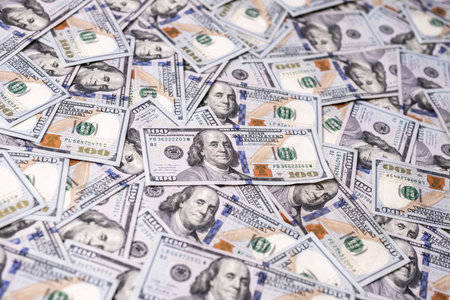 Money background with 100-dollar bills. Texture of US currency. 100 USD banknotes background. American hundred-dollar notes background. Pattern of US dollars for finance concept. USA many background.の写真素材