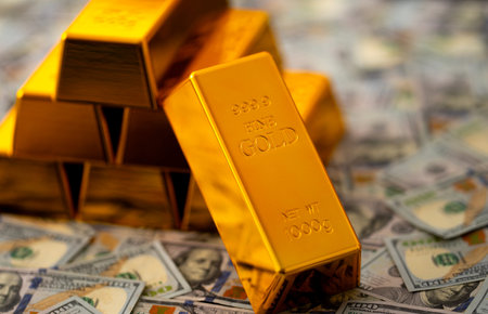 Gold and money. Gold secure investment. Golden bullion bars stacked with US dollars for financial...