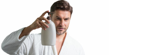 Cosmetics male products. Man hold bottle with dispenser pump for liquid soap, gel or foam, beauty product and cosmetics. Banner for header, copy space. Poster for web design. Beauty concept.の写真素材