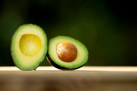 Fresh avocado half on background. Green organic avocado sliced in half. Fresh ripe avocado. Raw avocado.の写真素材
