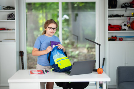 Kid on online lesson in home school. Child learning knowledge through homeschooling and online classes. Young student focused on virtual lesson at home school desk. Boy studying mathematics online.の写真素材