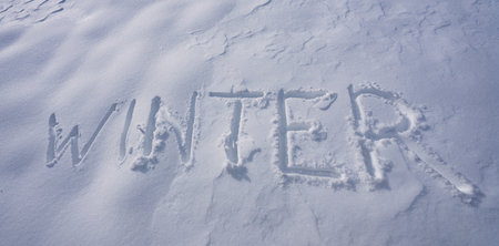 Winter design. Winter text with snow texture. Winter banner design. Snow text on icy surface. Frozen background with snow word. Snowy surface with clean winter banner.の写真素材
