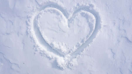 Frozen heart symbol on winter field. Wintertime snow heart backdrop. Love shaped snow. Minimal winter heart design. Serene frost heart on snowy ground. Winter romantic theme.の写真素材