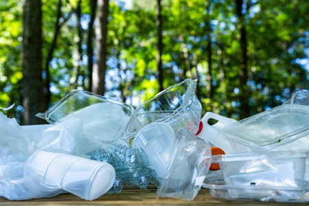 Plastic trash waste is a global problem. Recycling trash helps protect the environment. Trash harms nature and wildlife. Recyclable trash reduce pollution. Green planet. Reducing waste.の写真素材