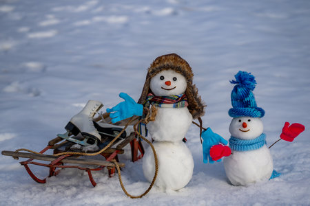 Snow man for winter holiday card background. Snowman outdoors in snow. Snowman with scarf outdoors in winter. Snowman for Christmas greeting card.の写真素材