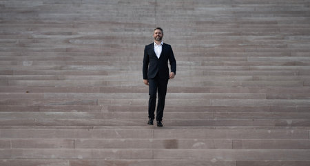 Business man walking up stairs. Career growth and success. Business step. Future goal and victory. Manager on stairs. Man climbing on stairs. Man in a suit moving up stairs. Goal concept.の写真素材