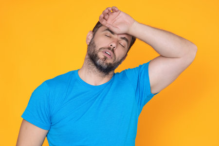 Sad man got migraine. Man with strong headache. Stressed, tired man from headache. Headache, tiredness and stress, migraine. Headache pain concept.の写真素材