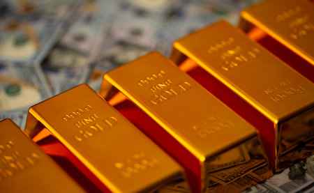 Gold and money. Gold secure investment. Golden bullion bars stacked with US dollars for financial...