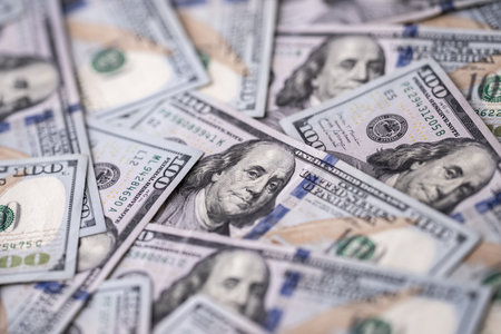 Money background with 100-dollar bills. Texture of US money currency. 100 USD banknotes in focus. American hundred-dollar money. Pattern of US dollars. Money for finance concept.の写真素材