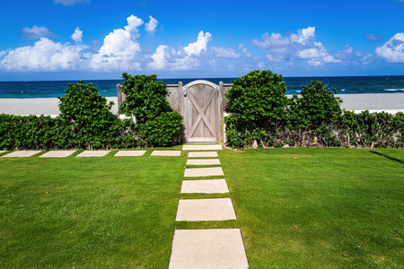 Tropical beach house with ocean view and palm trees. Resort paradise for relaxation and travel. Idyllic coastal. Perfect holiday getaway with ocean breeze.の写真素材