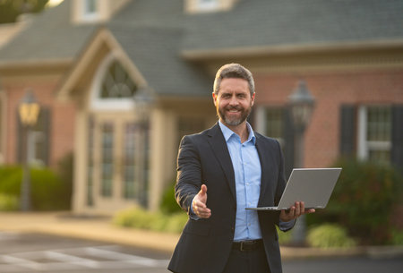 A realtor hands keys to a happy homeowner. Real estate agent inspects an apartment interior. Agent explains property financing. A real estate broker stands confidently outside a residential building.の写真素材