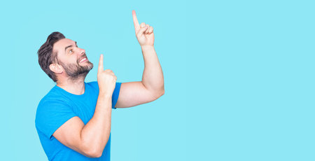 Man points gesture. Portrait of mature man with pointing on copy space or advertising. Pointing gesture. Promo pointing. Male model finger point.の写真素材