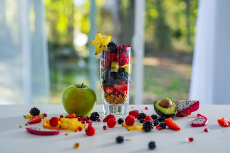 Assorted Fruit Cocktail with Fresh Tropical Berries. Cocktail of Mixed Fruits in Glass Bowl. Fruit Cocktail. Healthy Fruit Cocktail with Vegetarian Ingredients.の写真素材