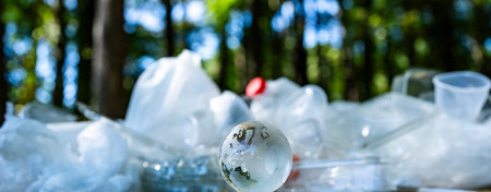 Trash litters forests. Plastic pollutes on green nature. Waste harms wildlife habitats. Garbage spreads across natural landscapes.の写真素材