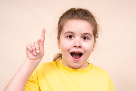 Kid with idea. Child points up in excitement. Surprised kid shows idea. Excited child inspiration....